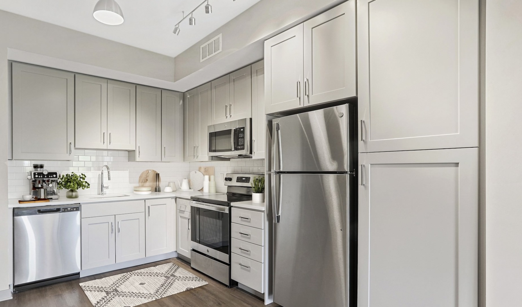 Kitchen with white cabinetry and stainless steel appliances 