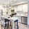 Model kitchen at our apartments for rent in Fairfax, VA, featuring stainless steel appliances and wood grain floor paneling.