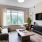 Model living room at our apartments for rent in Fairfax, VA, featuring wood grain floor paneling and a flat screen TV.