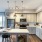 Model kitchen at our apartments for rent in Fairfax, VA, featuring stainless steel appliances and wood grain floor paneling.