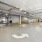 The parking garage at our apartments for rent in Fairfax, VA, featuring cars parked in rows and traffic arrows.